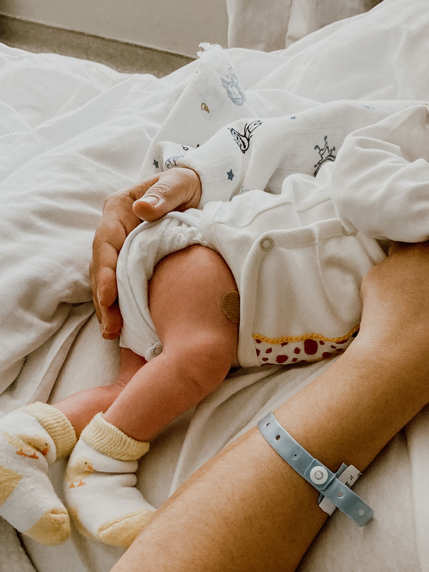 A parent holding a newborn baby