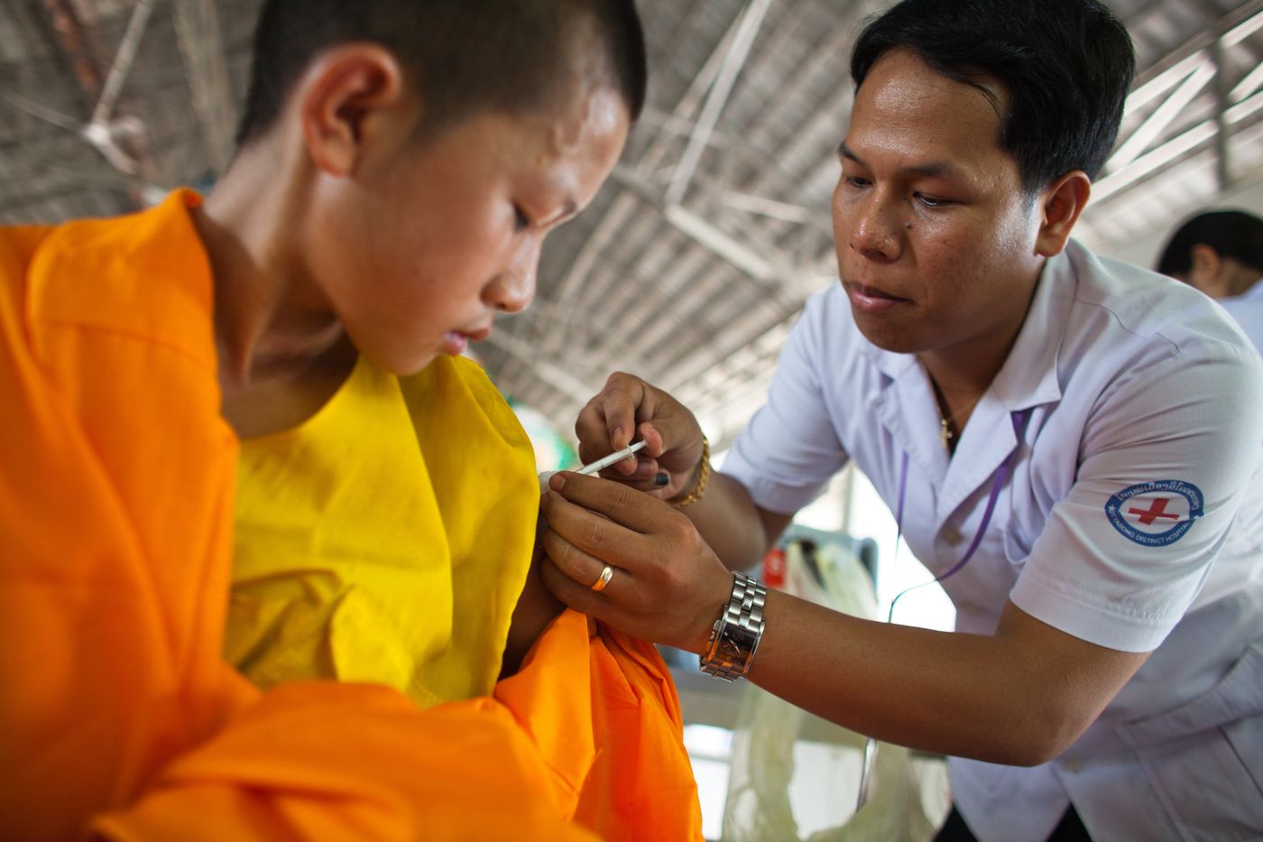A healthcare worker giving a vaccine to a child