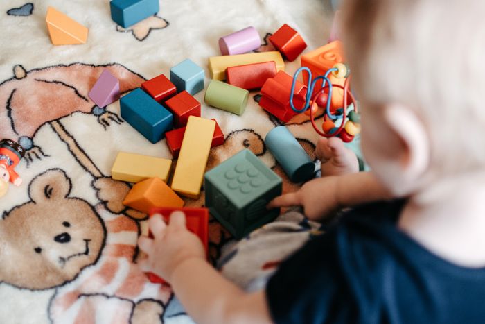 A toddler playing with colorful building blocks